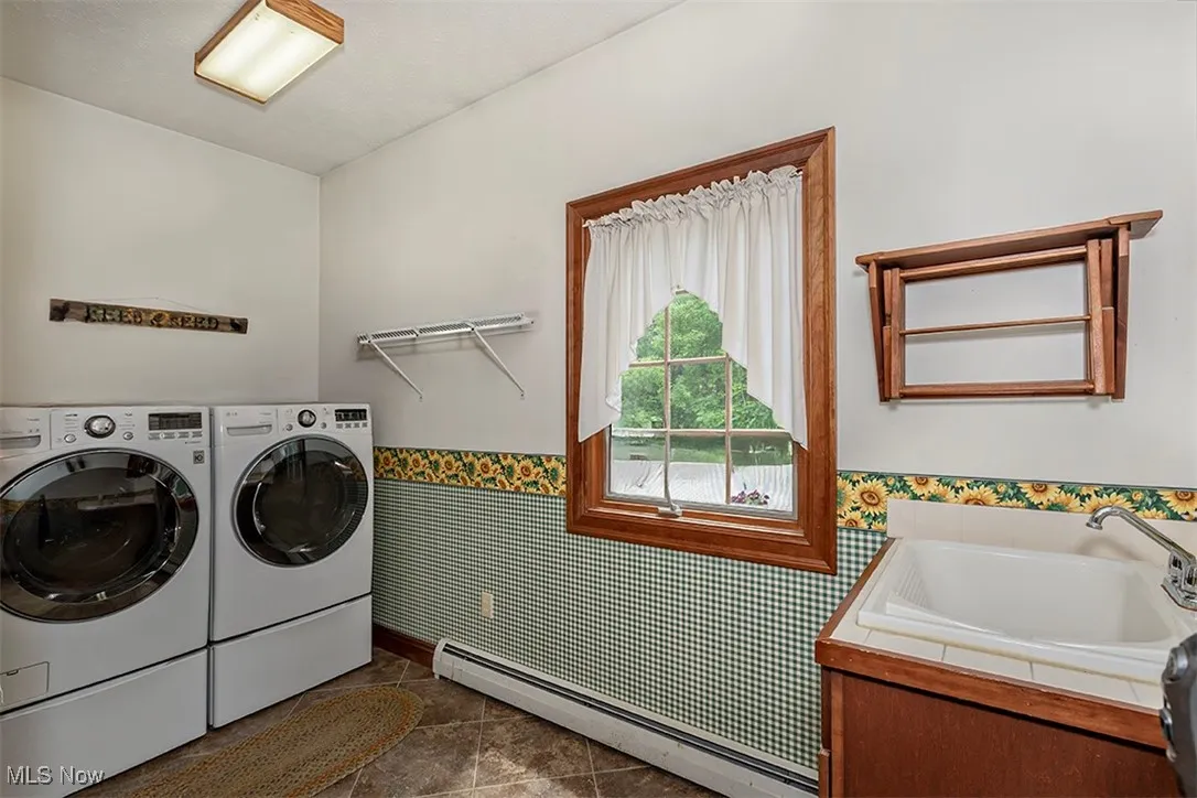 Extra space is always welcomed in the laundry room ! Utility sink inset into storage cabinet.