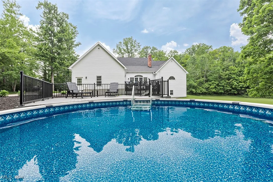 Above-ground pool is inset into a deck system set up for maximum enjoyment amid total privacy.
