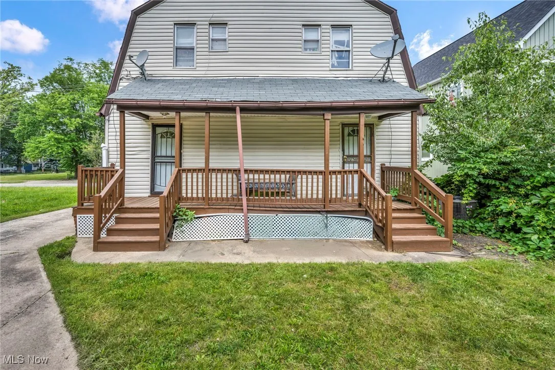 Colonial inspired home with a gambrel roof, covered porch, and roof with shingles