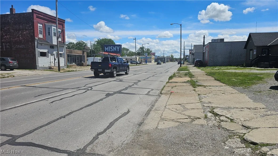 View of asphalt road featuring sidewalks, street lighting, and​​‌​​​​‌​​‌‌​‌‌​​​‌‌​‌​‌​‌​​​‌​​ curbs
