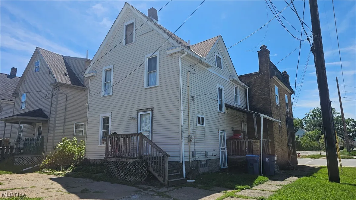 Rear view of house featuring a chimney