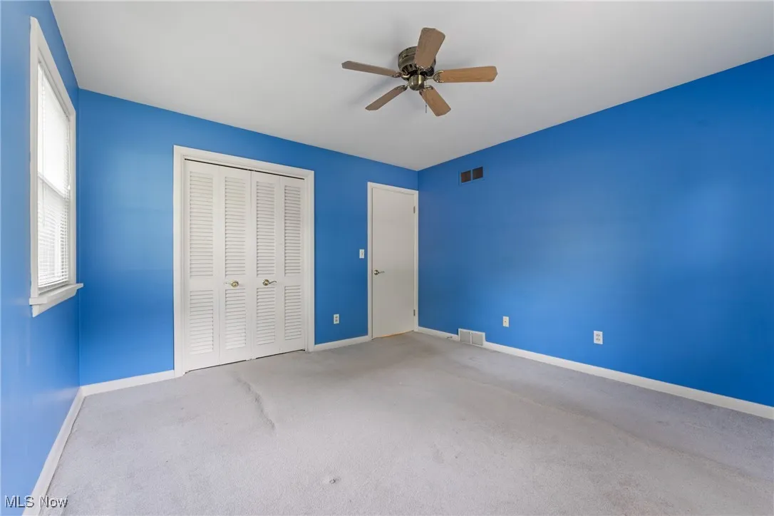 Unfurnished bedroom with carpet floors, a closet, and ceiling fan