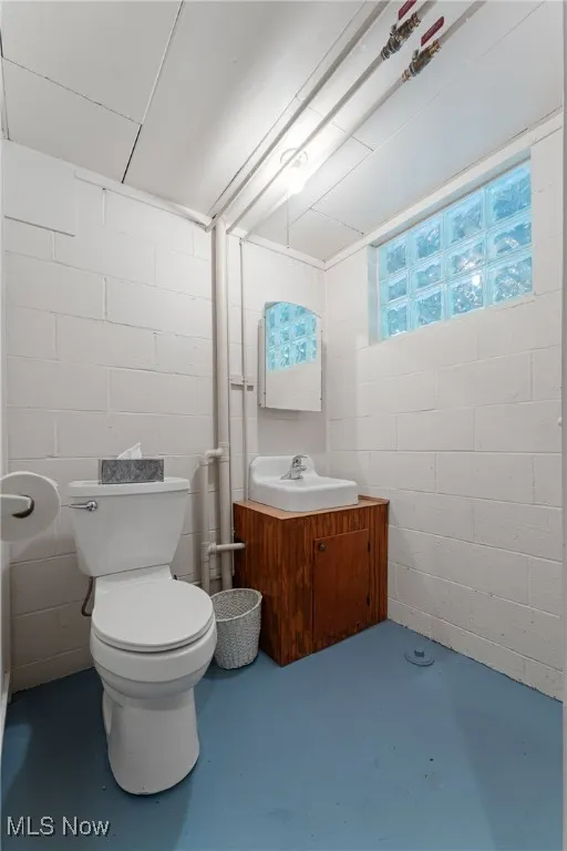 Bathroom with concrete floors and vanity