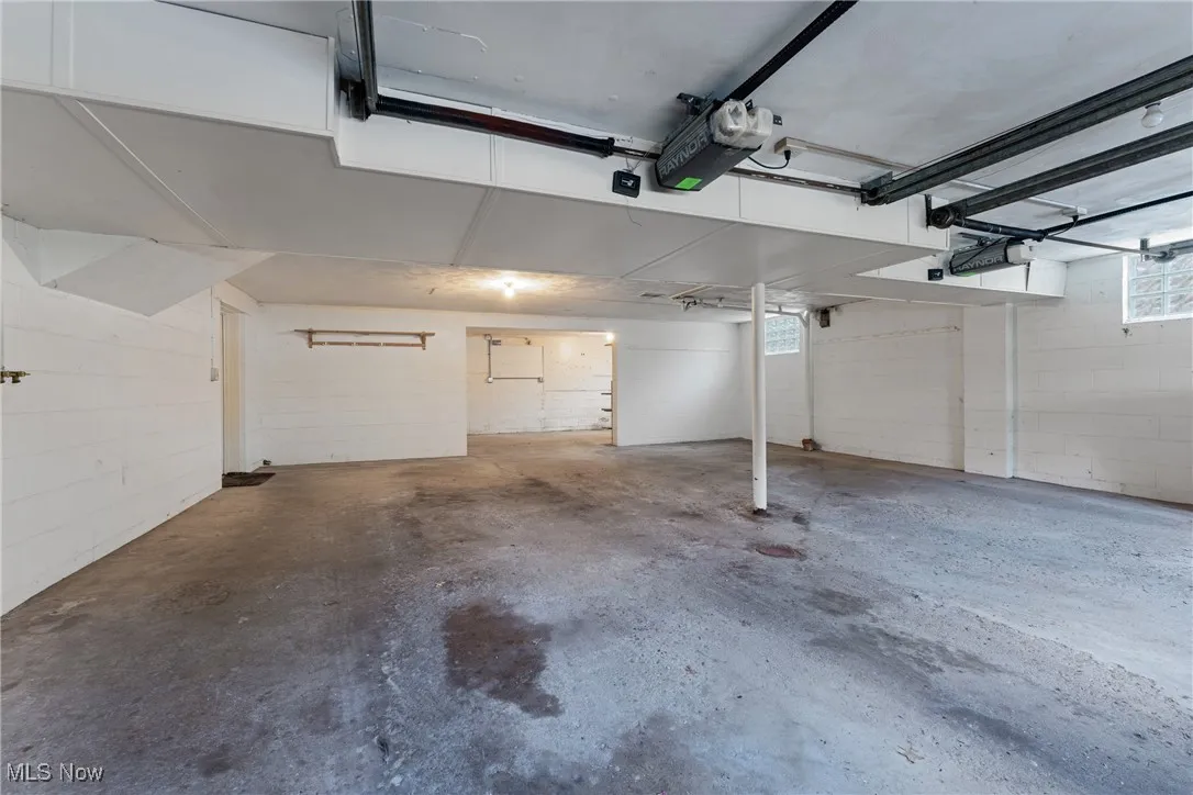 Garage with a garage door opener and concrete block wall