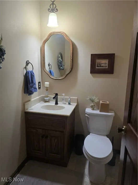 1/2 Bathroom with vanity and toilet on main level.