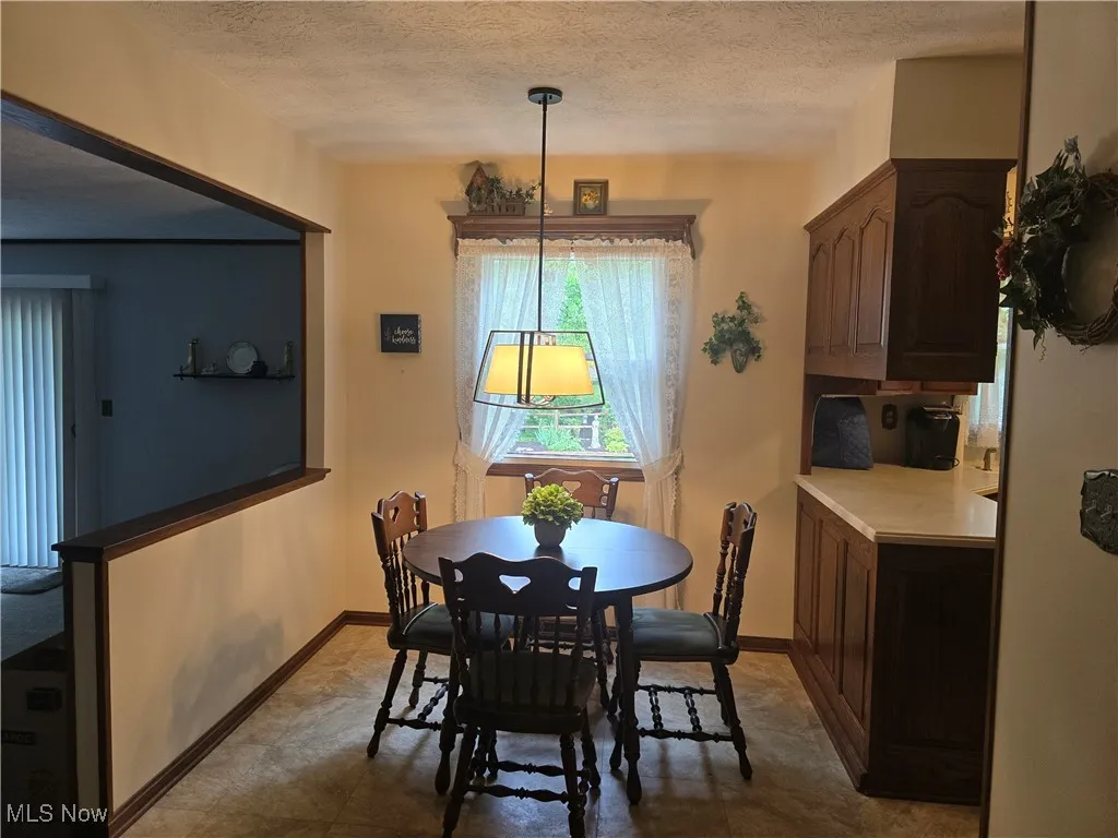 Dining area featuring a textured ceiling and vinyl flooring