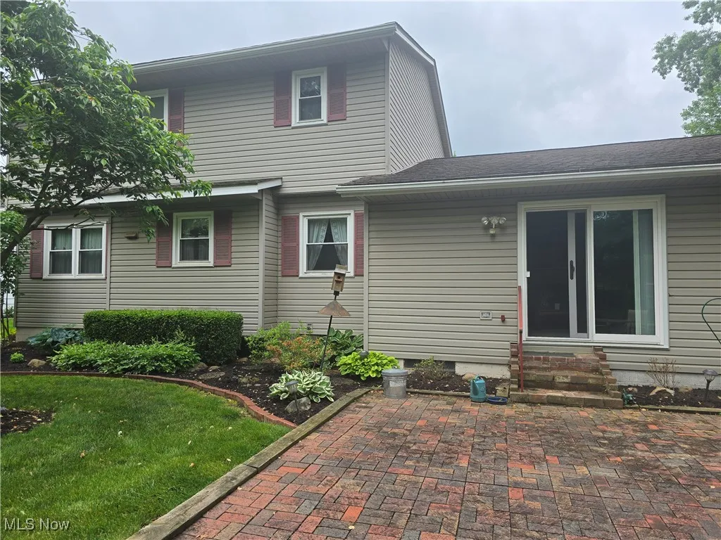 Rear view of property with brick patio