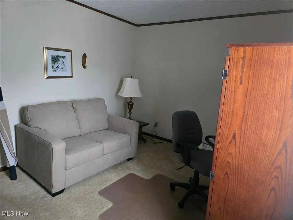 Third bedroom currently used as office with crown molding and baseboards