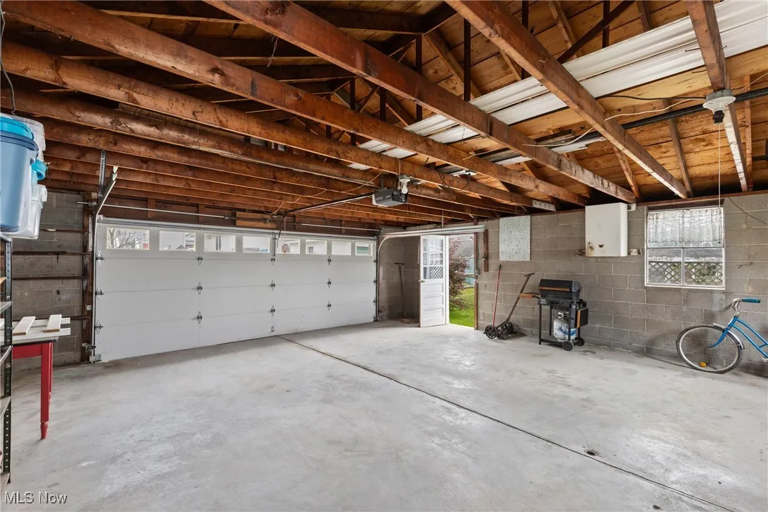 Garage with a garage door opener and concrete block wall