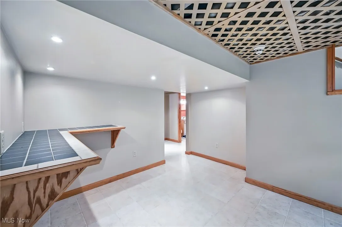 Finished basement with baseboards and recessed lighting