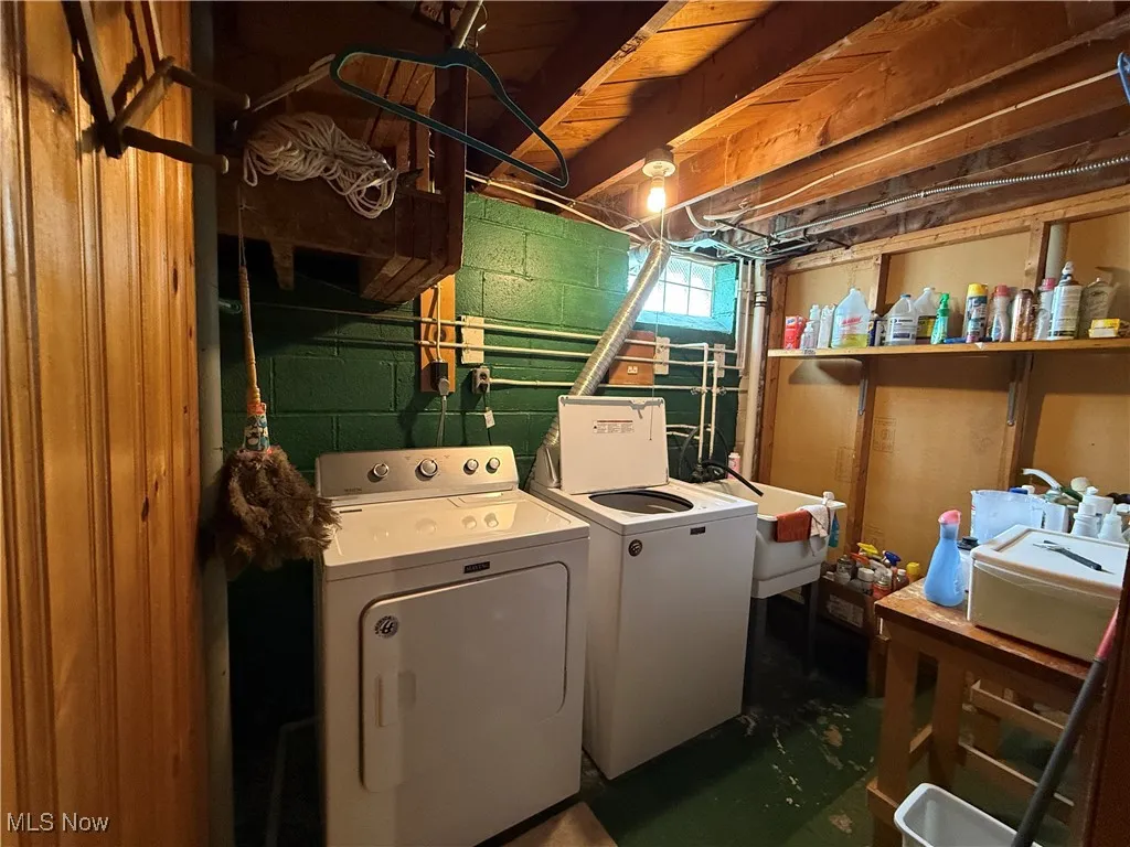 Washroom with washing machine and clothes dryer