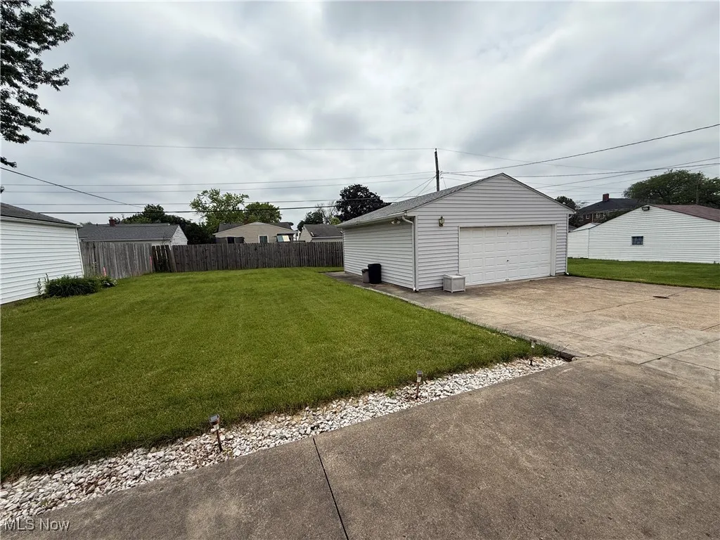 View of yard featuring a detached garage and an outdoor structure