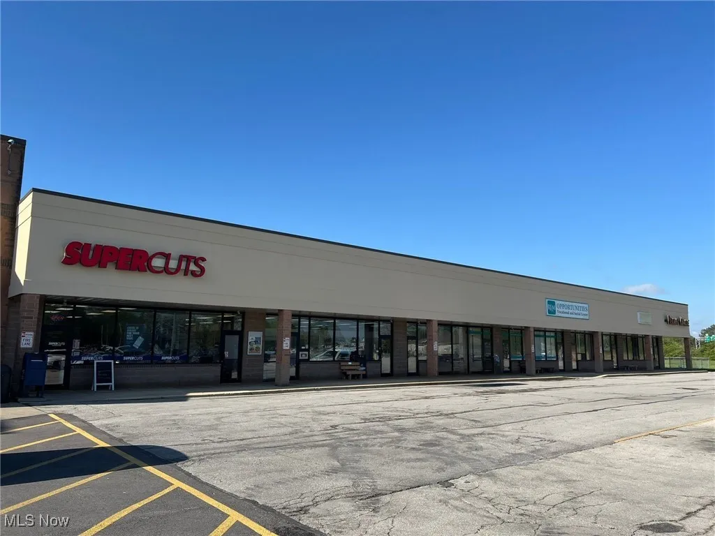 View of commercial location with uncovered parking