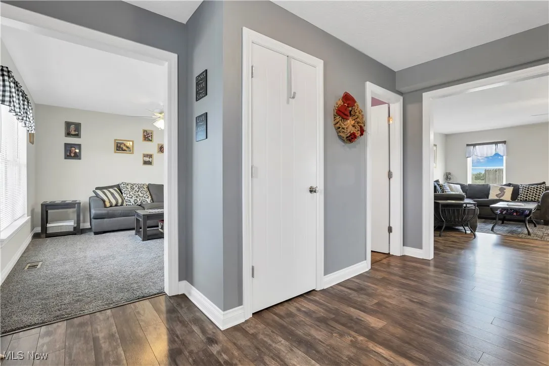 Hallway with dark wood finished floors and baseboards