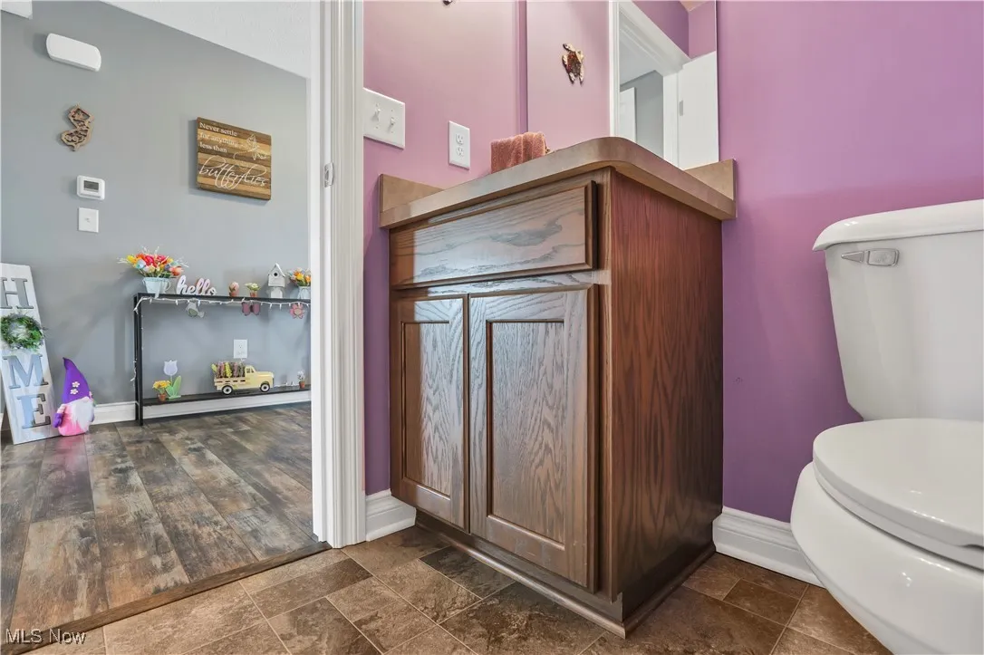 Bathroom featuring toilet and baseboards