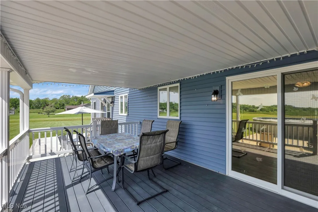Wooden deck featuring outdoor dining space