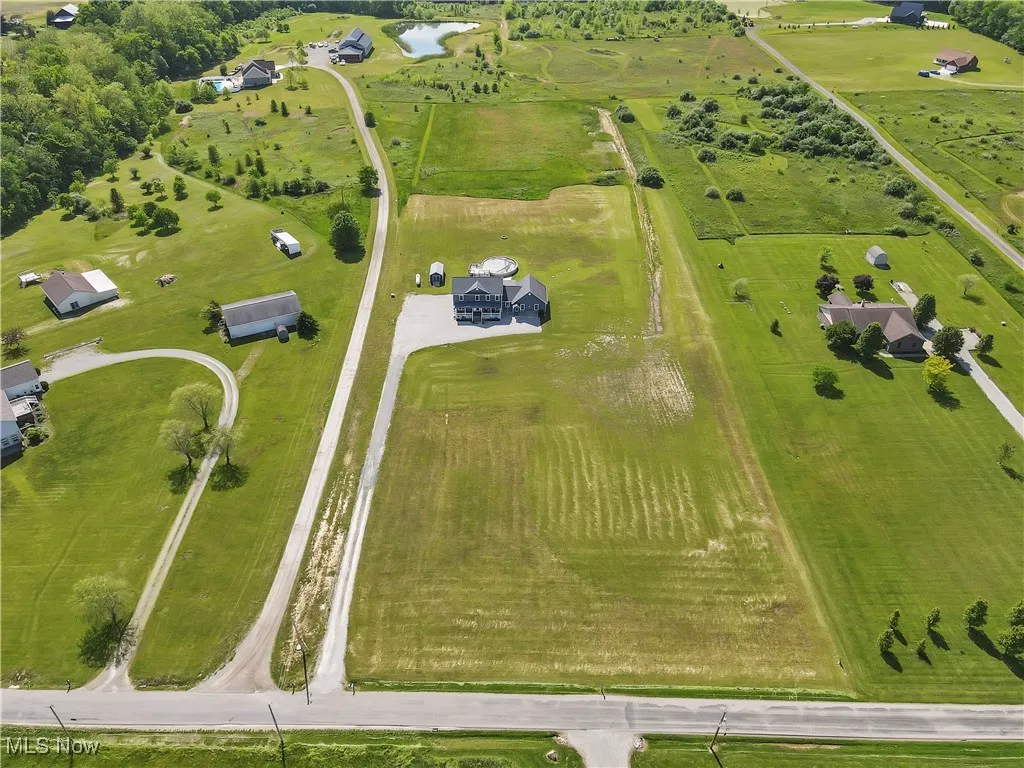 Aerial view of sparsely populated area featuring a nearby body of water