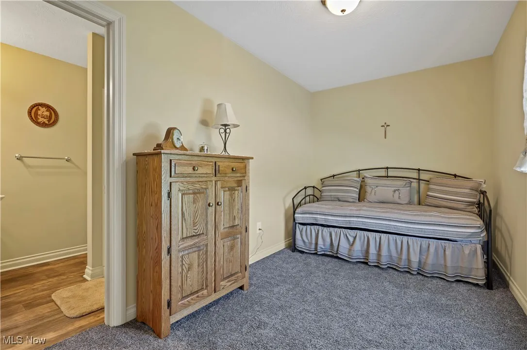 Bedroom with baseboards and carpet floors