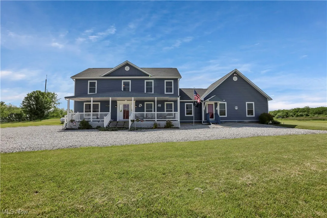 View of front of house with a porch and a front yard