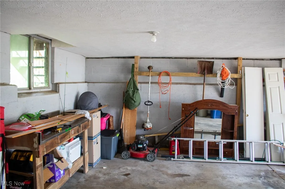 Garage featuring concrete block wall