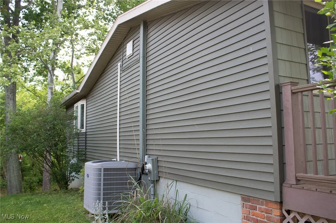 View of home's exterior featuring cooling unit