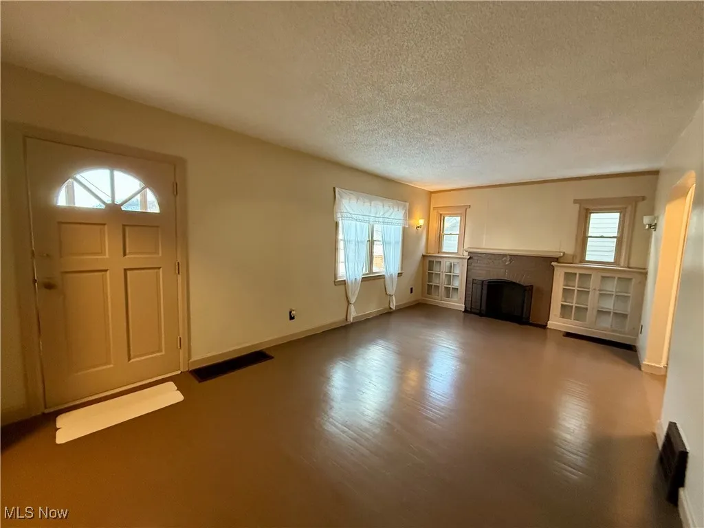 Unfurnished living room with a textured ceiling