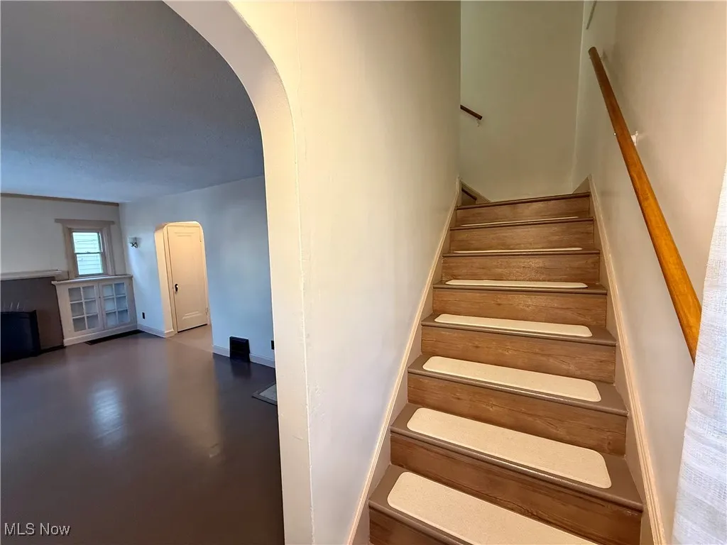 Stairs featuring hardwood / wood-style floors