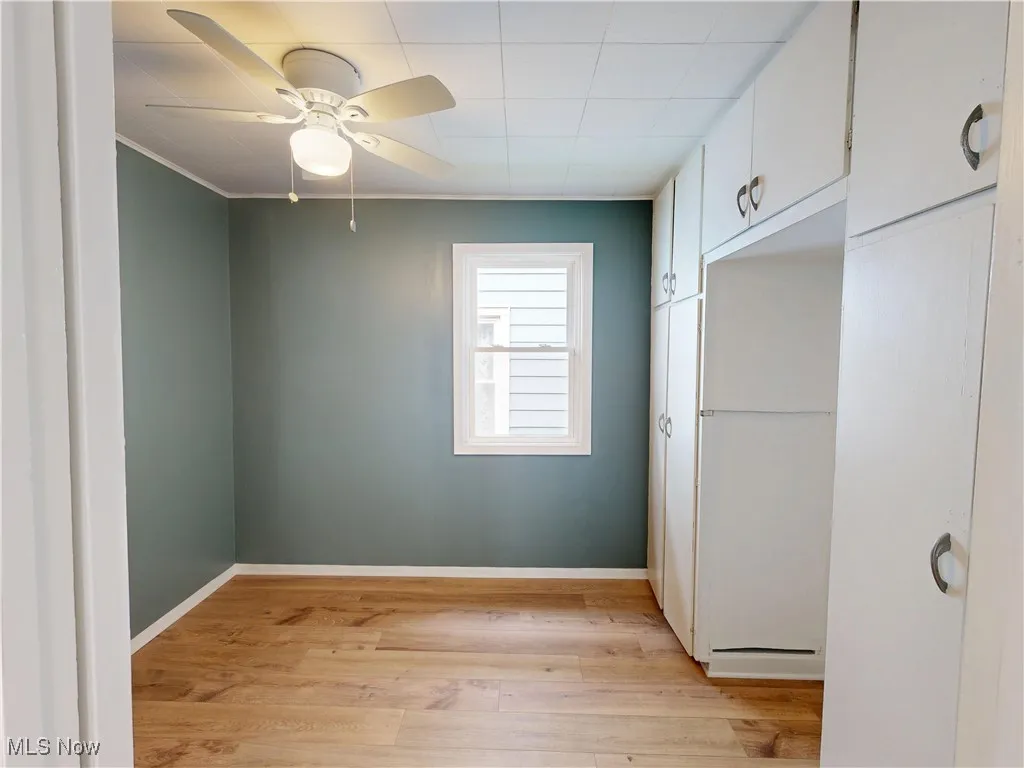 Unfurnished bedroom featuring light wood-style flooring, baseboards, and ceiling fan