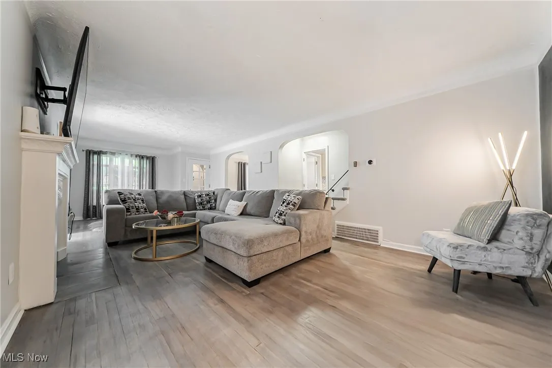 Living area featuring wood finished floors and arched walkways