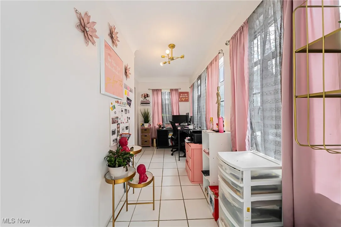 Office featuring light tile patterned floors and a chandelier