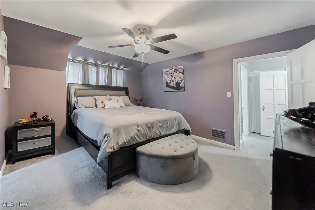 Bedroom featuring ceiling fan and light carpet