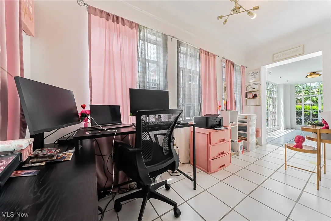 Office area with light tile patterned floors and a chandelier
