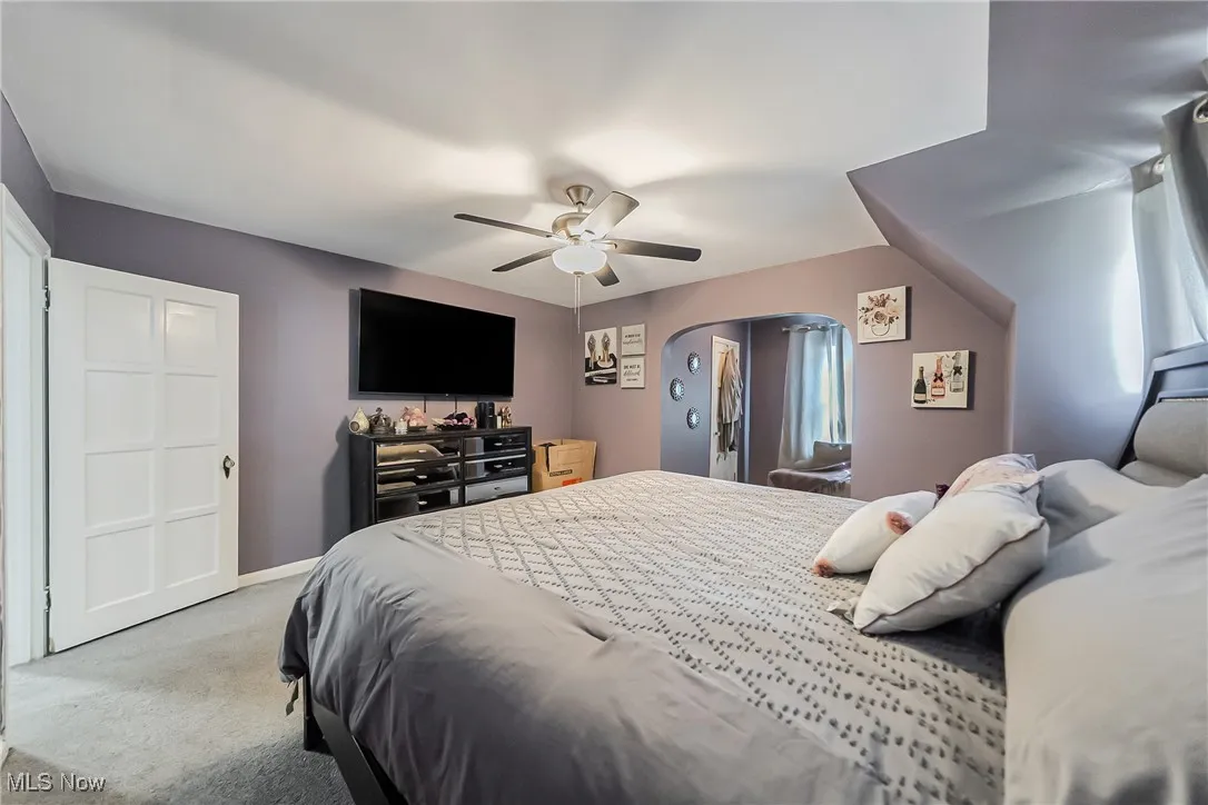 Bedroom featuring light colored carpet and ceiling fan