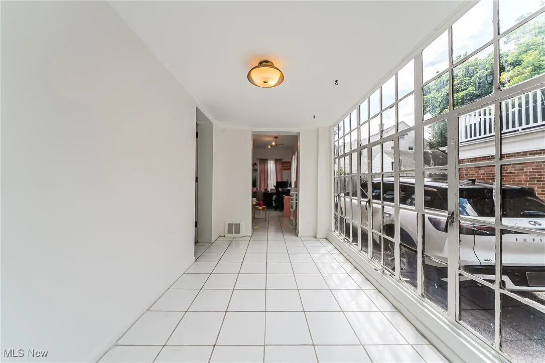 Hall featuring tile patterned flooring