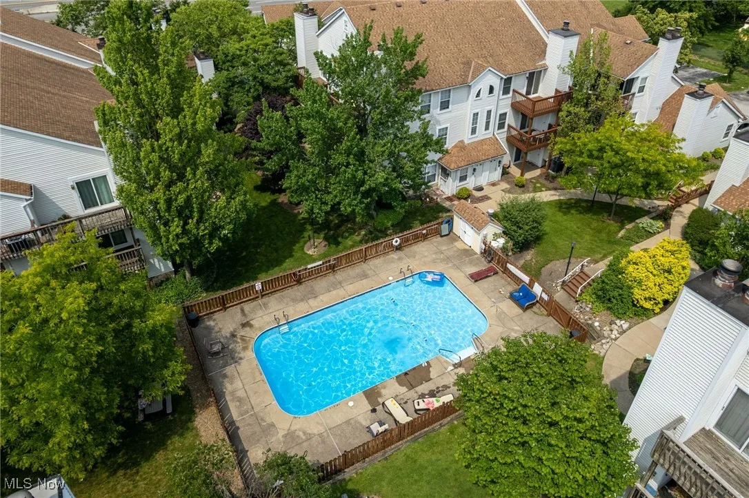 Aerial perspective of suburban area featuring a pool