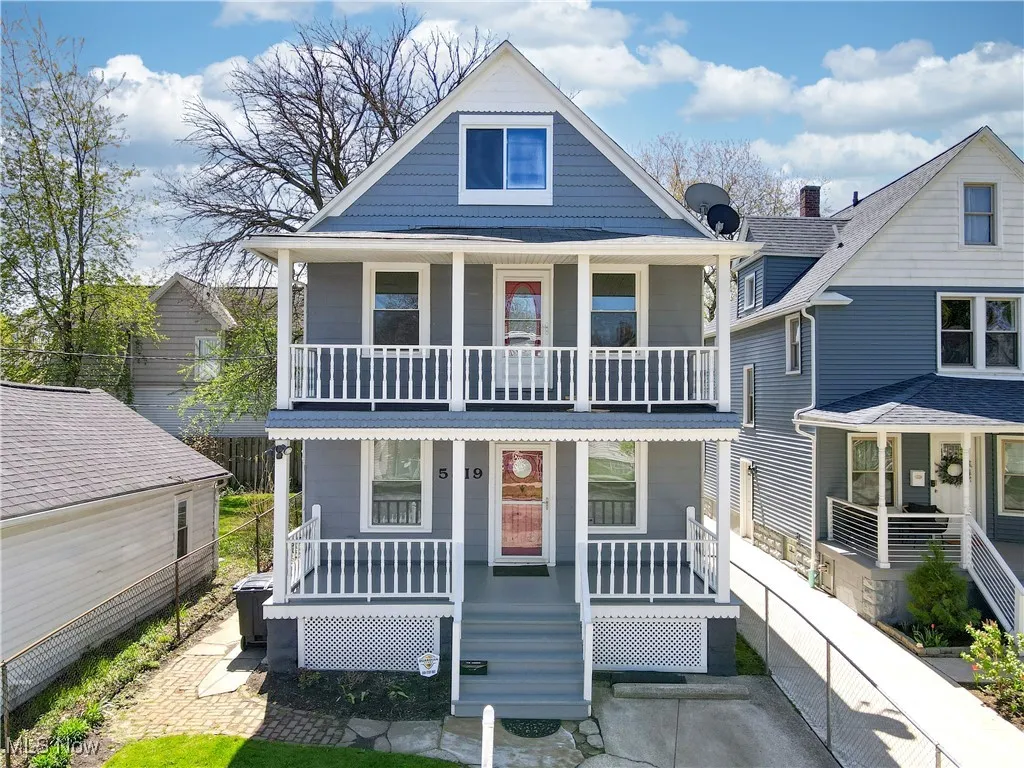 View of front of home with covered porch and a balcony