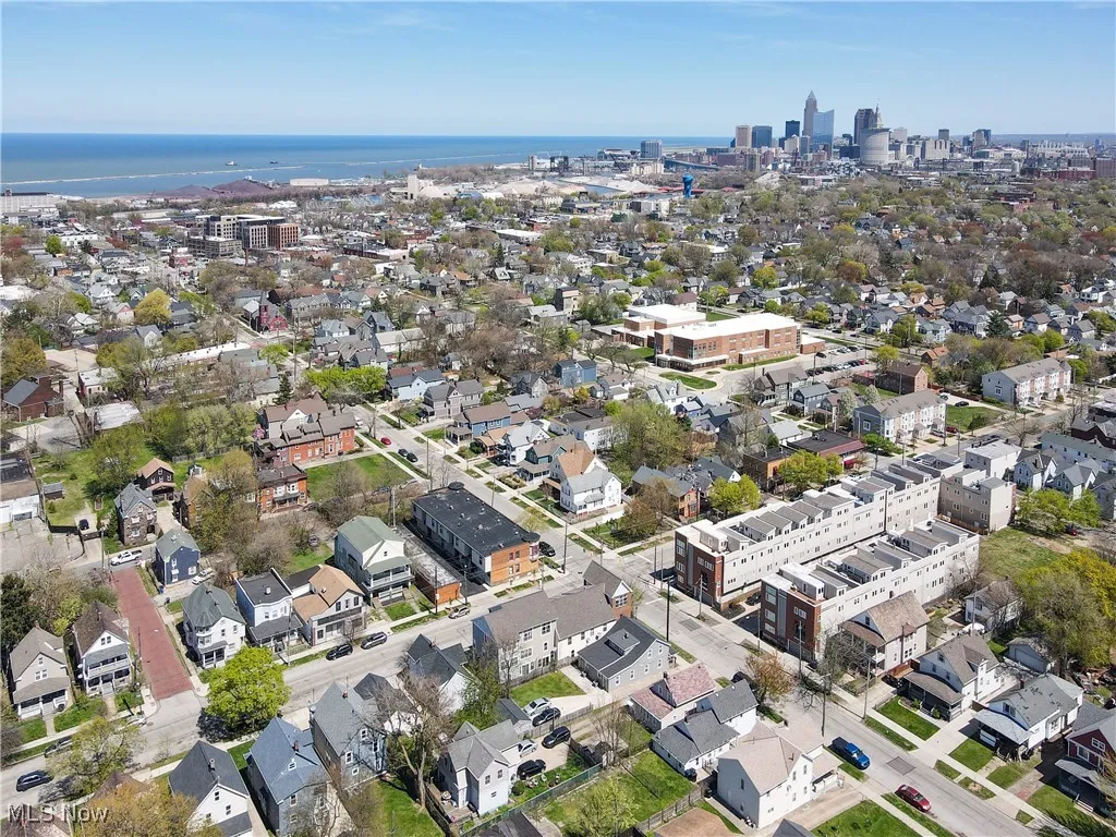 Aerial view of property and surrounding area with nearby urban area