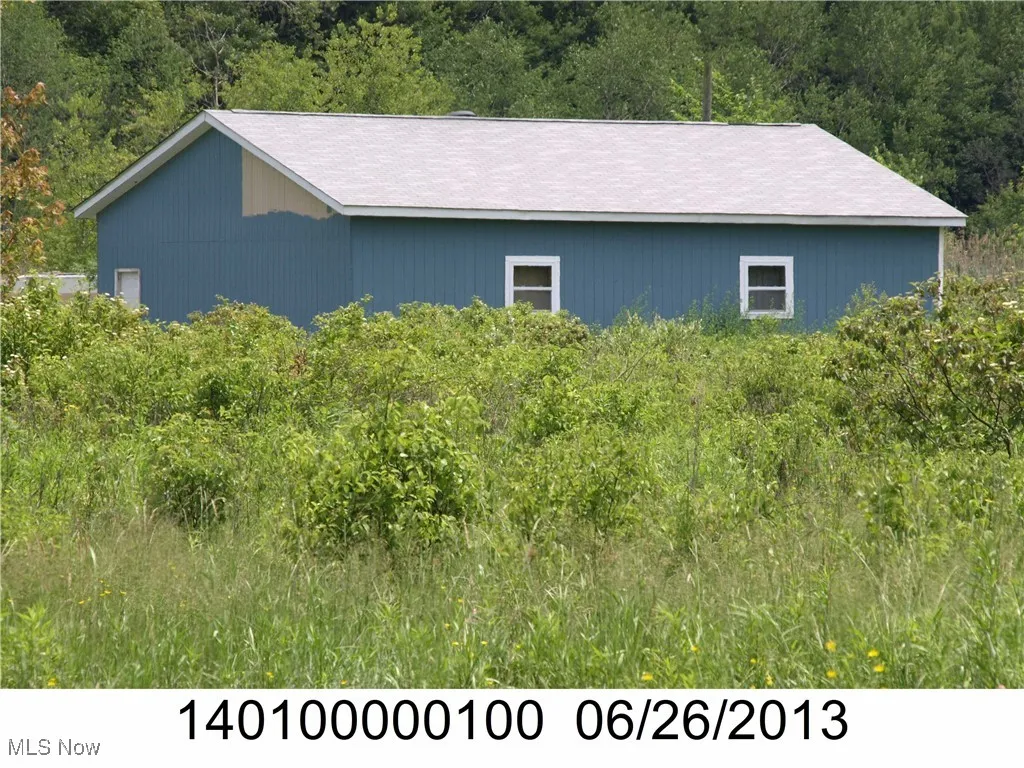 View of home's exterior featuring a view of trees