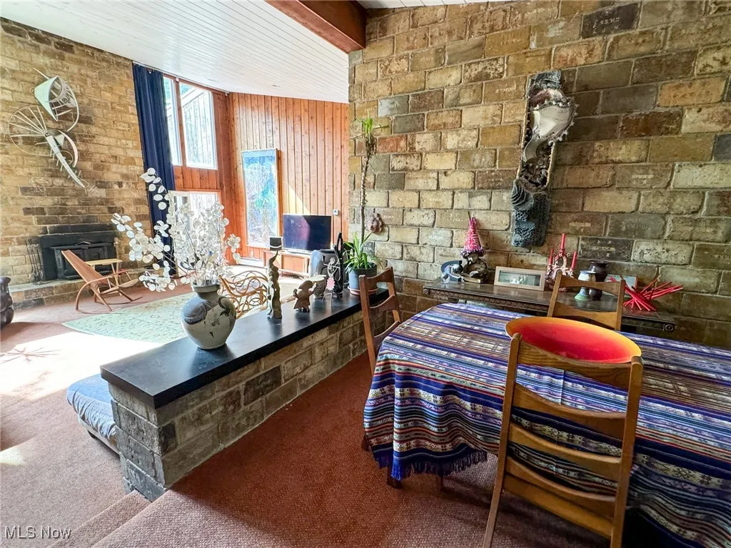 Carpeted living room featuring a wood stove