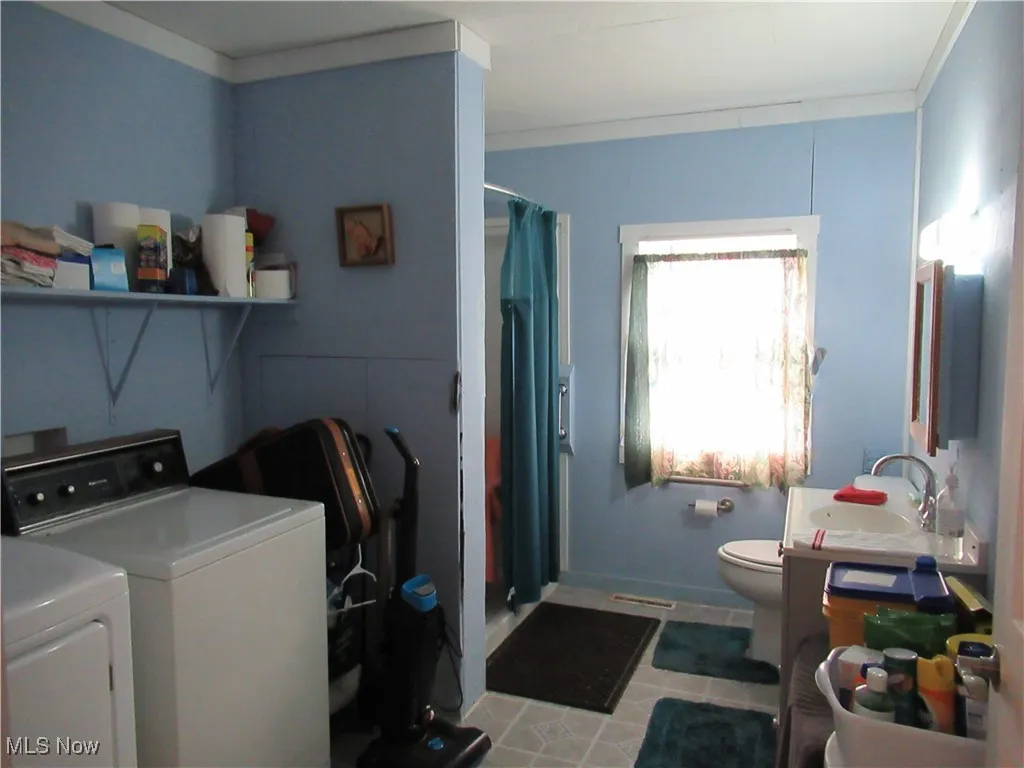 Full Bath with Shower /  Laundry area    Washer and Dryer stay with the home