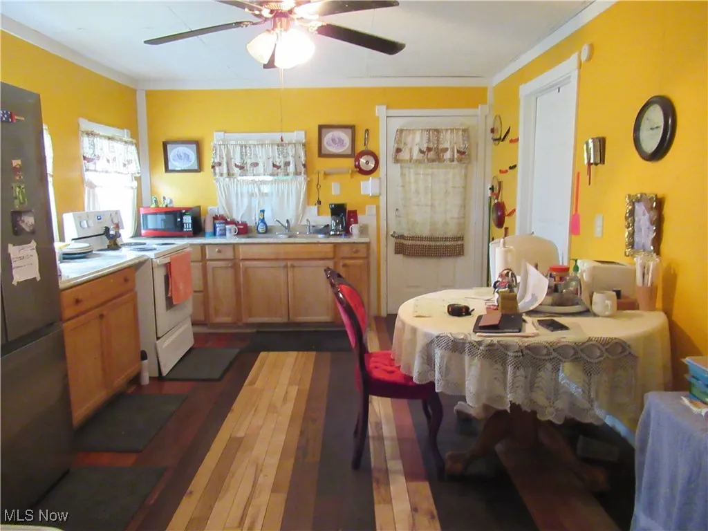 Kitchen with ceiling fan and wood flooring