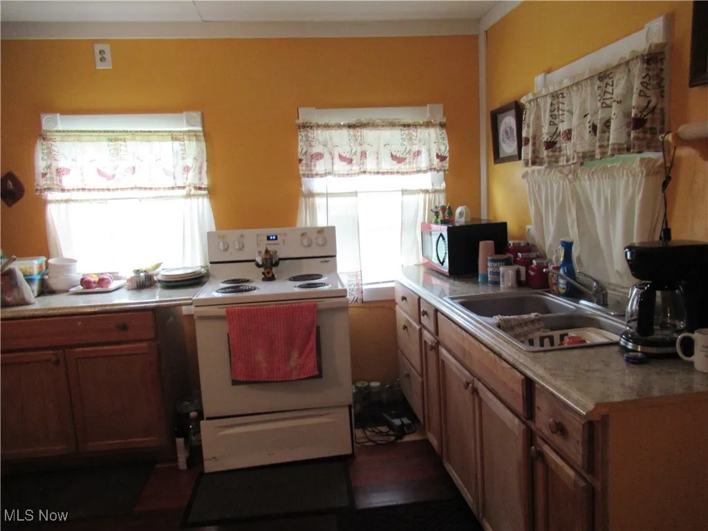 Electric stove and sink area seen here