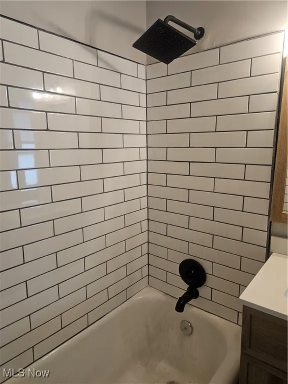 Full bathroom featuring shower / washtub combination and vanity