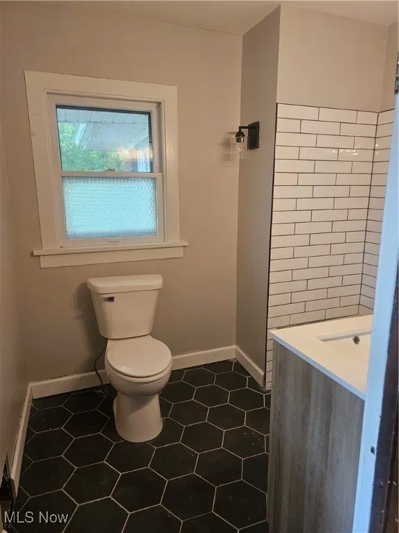 Bathroom featuring toilet and tile patterned flooring