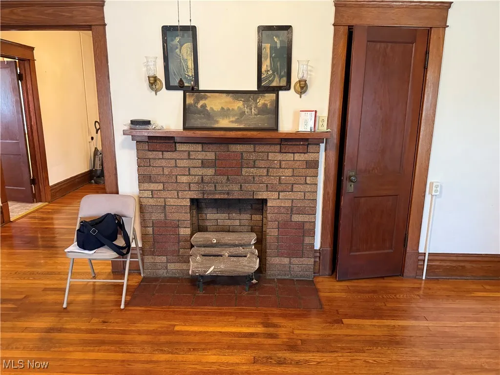 Living area featuring wood finished floors and a brick fireplace