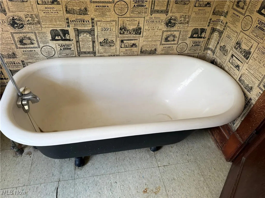 Bathroom view of heating fuel tank and a freestanding bath