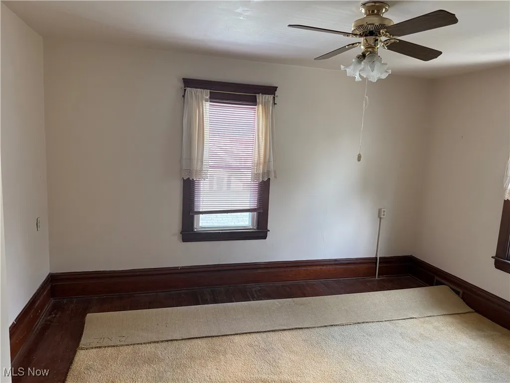 Spare room featuring wood finished floors and ceiling fan