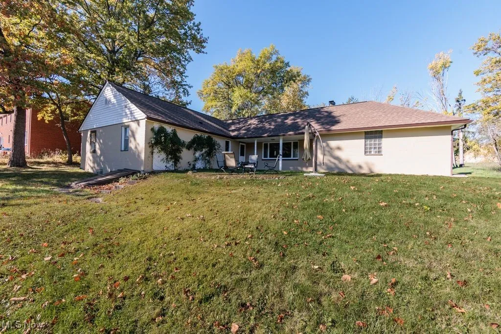 Rear view of property featuring a yard