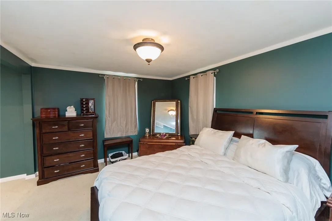 Bedroom with carpet floors and baseboards