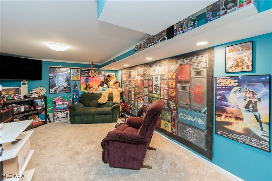 Carpeted living area with recessed lighting